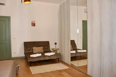 a living room with a couch and a mirror at Hideaway 65 - Home by St Peter's in Rome