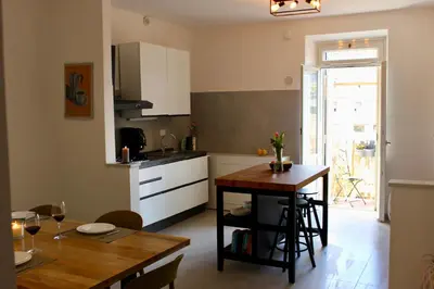 a kitchen and dining room with a table and a table and a dining room at Hideaway 65 - Home by St Peter's in Rome