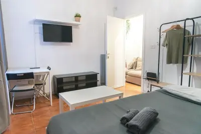 a bedroom with a bed with a black wall at Station Loft Trastever's Homies in Rome