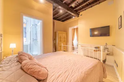 a bedroom with a bed and a tv on the wall at Secret Luxury Retreat in the Heart of the Ghetto by Houseeds in Rome