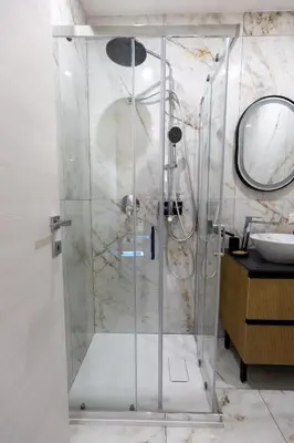 a shower with a glass door in a bathroom at Hadrian's House in Rome