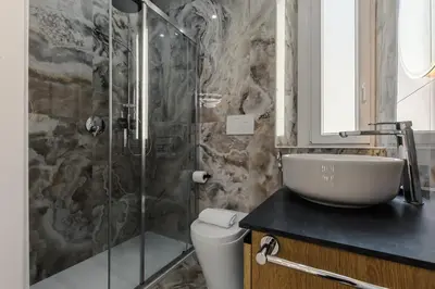 a bathroom with a shower and a sink and a toilet at Hadrian's House in Rome