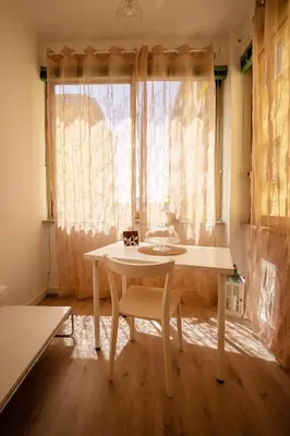 a white table and chair in a room with a window at CaSa e Caffarella in Rome