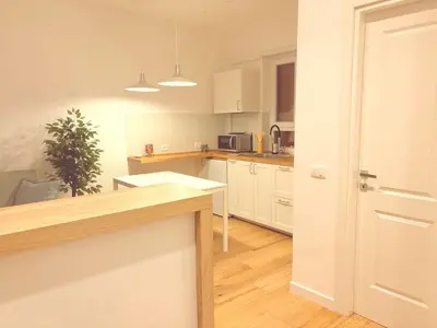 a kitchen with white cabinets and a counter top at Casa Vacanze Leone in Rome