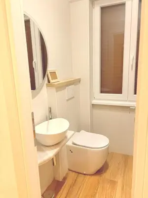 a bathroom with a white toilet and a sink at Casa Vacanze Leone in Rome