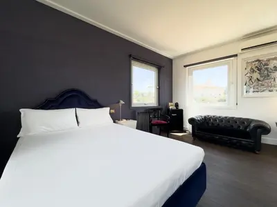 a bedroom with a large bed and a couch at Chasing the Stars Spanish Steps Boutique Suite in Rome