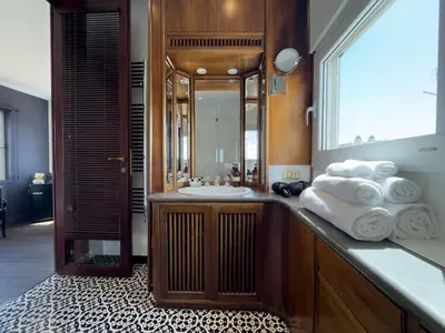 a bathroom with a sink and a mirror and towels at Chasing the Stars Spanish Steps Boutique Suite in Rome