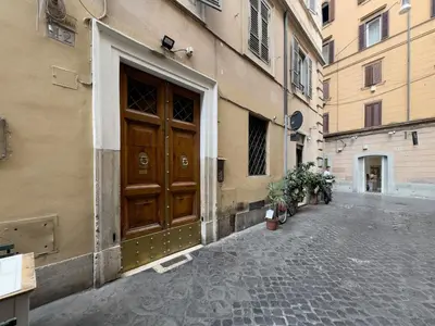 a building with a wooden door on a street at Chasing the Stars Spanish Steps Boutique Suite in Rome