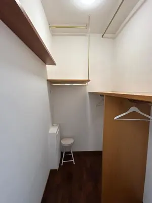 a small room with a closet and a stool at Green house - appartamento rome in Rome