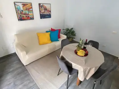 a living room with a table and a white couch at Domus Pacis in Rome