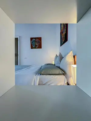 a bedroom with a bed with white sheets and pillows at Inn Pantheon Home in Rome