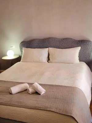 a large bed with a pair of socks on it at Suite Benedict Pantheon in Rome