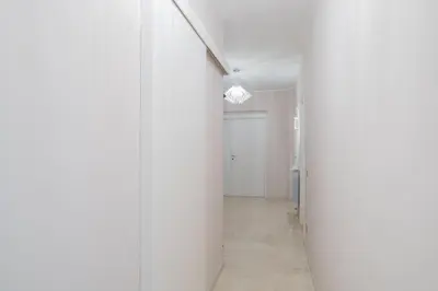 a hallway with white walls and a white door at B&B Damagi in Rome