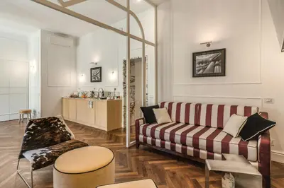a living room with a couch and a table at Piazza Venezia Luxe Apartment in Rome