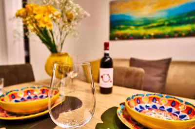 a table with two glasses and a bottle of wine at Vatican Meadows Apartment in Rome