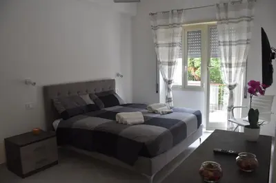 a bedroom with a large bed and a window at Casa Vacanza SADAMA in Rome