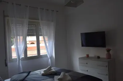 a bedroom with a bed and a television and a dresser at Casa Vacanza SADAMA in Rome