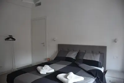 a bedroom with a bed with two towels on it at Casa Vacanza SADAMA in Rome