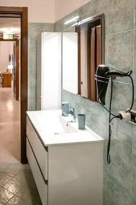 a bathroom with a sink and a mirror at Exquilia Home & Garden at the Colosseum in Rome