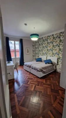 a bedroom with a bed and a wooden floor at Re di Roma vacation in Rome