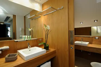 a bathroom with a sink and a mirror at Margutta 54 Luxury Suites in Rome