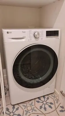 a white washing machine in a corner of a room at Jolegrè all'Opera in Rome