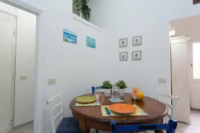 a dining room with a wooden table and chairs at La Casina di Luigi con balcone in Rome