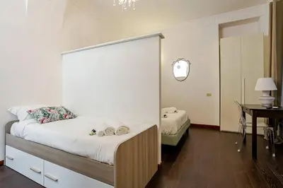 a bedroom with a bed and a table and a mirror at Fontana di Trevi a 2 passi in Rome