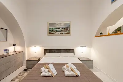 a bedroom with a bed with two white towels on it at casa cavour in Rome