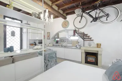 a bike hanging on the wall of a kitchen with a table at Your nest in Trastevere, the heart of Rome - Il vostro Nido nel cuore di Roma in Rome
