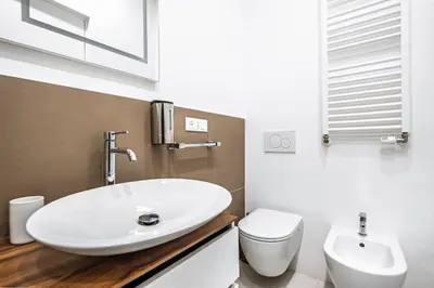 a bathroom with a white sink and a toilet at Stylish 1BR, 2BATH Apartment Castel Sant'Angelo 6A in Rome