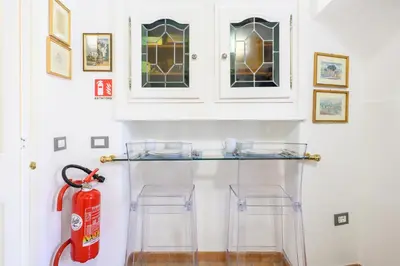 a room with a fire hydrant and two glass stools at Puccini Flat in Rome