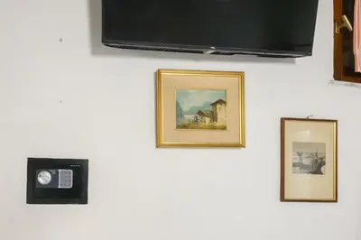 three pictures hanging on a wall with a tv at Puccini Flat in Rome