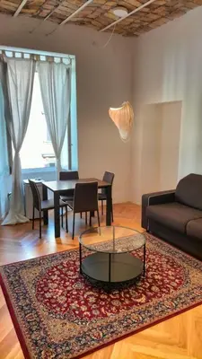 a living room with a table and a couch at Catone 34 in Rome