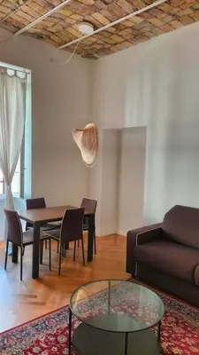 a living room with a couch and a table and chairs at Catone 34 in Rome