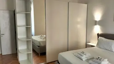 a bedroom with a mirror and a bed with towels at Catone 34 in Rome