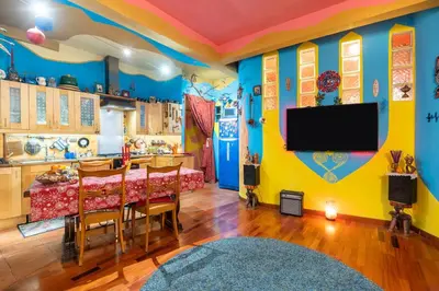a living room with a tv and a dining room at Fine Art House in Rome