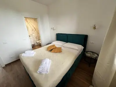 a bedroom with a bed with towels on it at LP San Giovanni Apartment in Rome