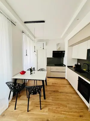 a kitchen with a table and chairs in a room at LP San Giovanni Apartment in Rome