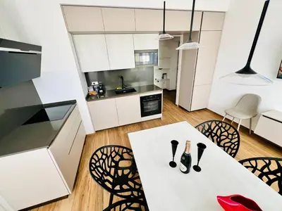 a kitchen and dining room with a white table and chairs at LP San Giovanni Apartment in Rome