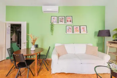a living room with a white couch and a table at Maison Rinascimento Roma in Rome