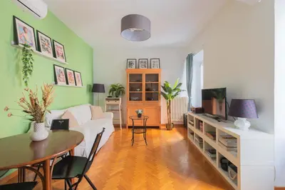 a living room with a white couch and a table at Maison Rinascimento Roma in Rome
