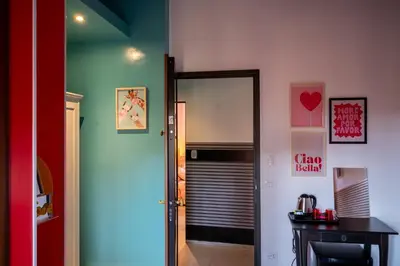 a hallway with a door leading to a room with a refrigerator at Sanlorenzo MaDa House in Rome