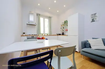 a kitchen and living room with a table and chairs at Casa Magnifica in Rome