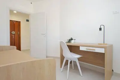 a white chair sitting at a desk in a room at Attico di Design a Garbatella con Vista San Pietro in Rome