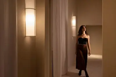 a woman in a black dress standing in a hallway at Velvet Grey Boutique Hotel Roma in Rome