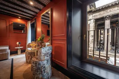 a room with red walls and a table and chairs at Pantheon Suite - Residenze di Charme in Rome