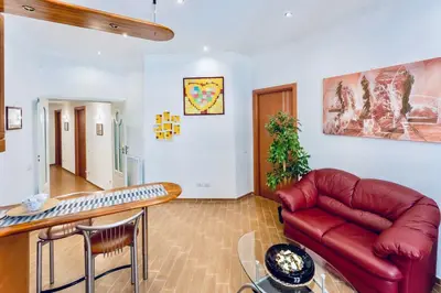 a living room with a couch and a table at MICLAD Colosseum Guest House in Rome