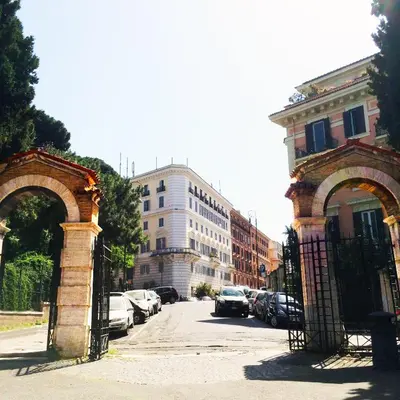 an archway in a city with cars parked on a street at MICLAD Colosseum Guest House in Rome
