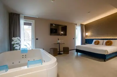 a large bathroom with a tub and a bed at Bocca di Leone Luxury Suite in Rome